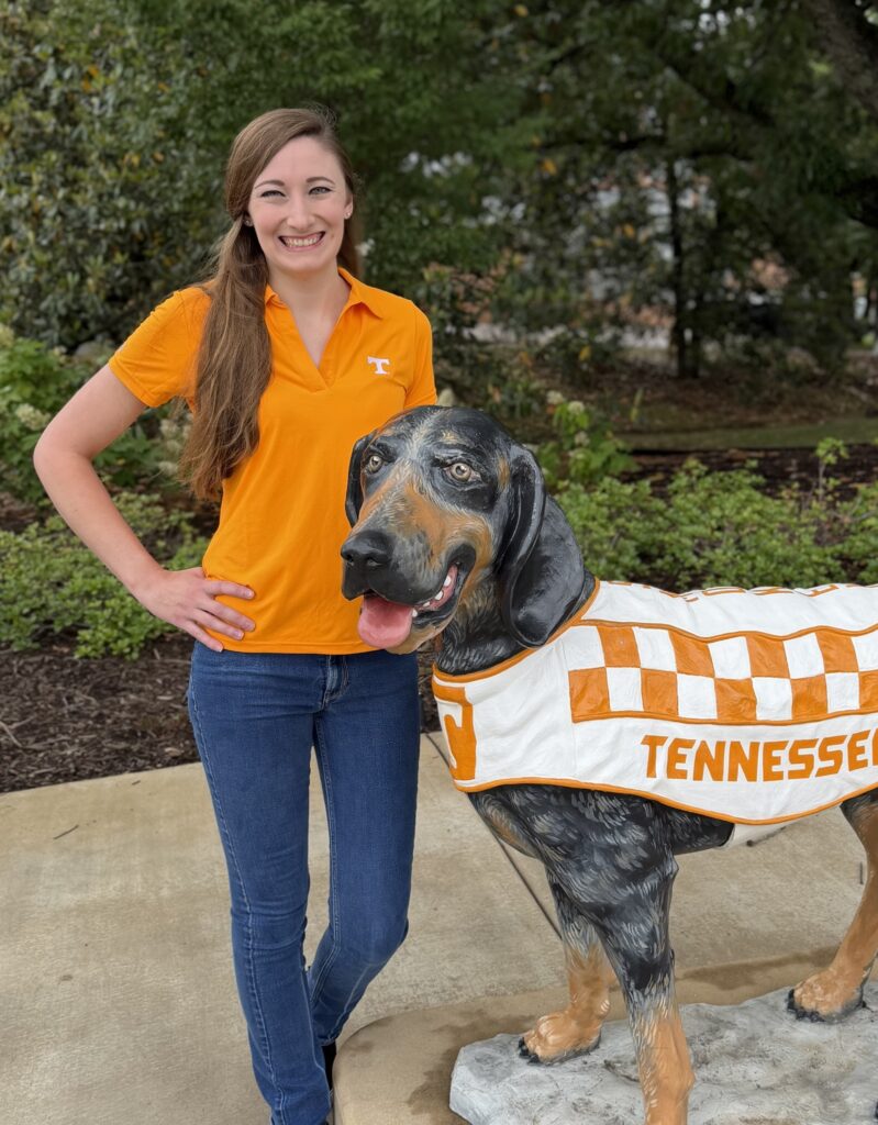 Taylor poses with Smokey statue on the University of Tennessee campus