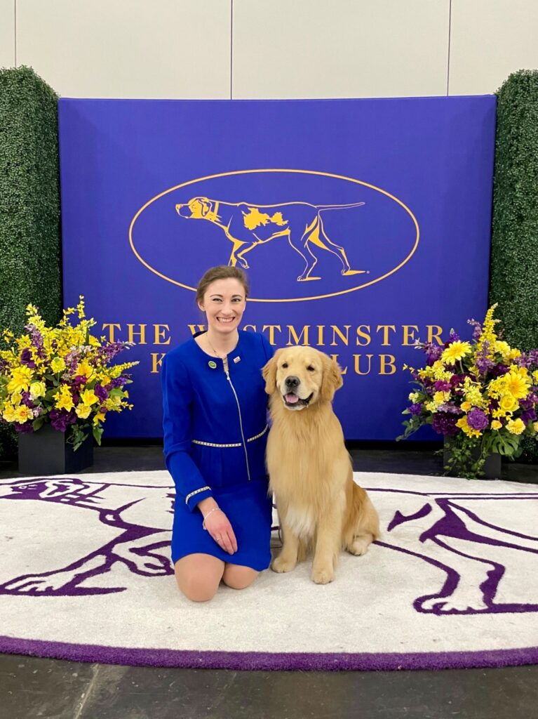 Taylor with a golden retriever at the Westminister Kennel Club